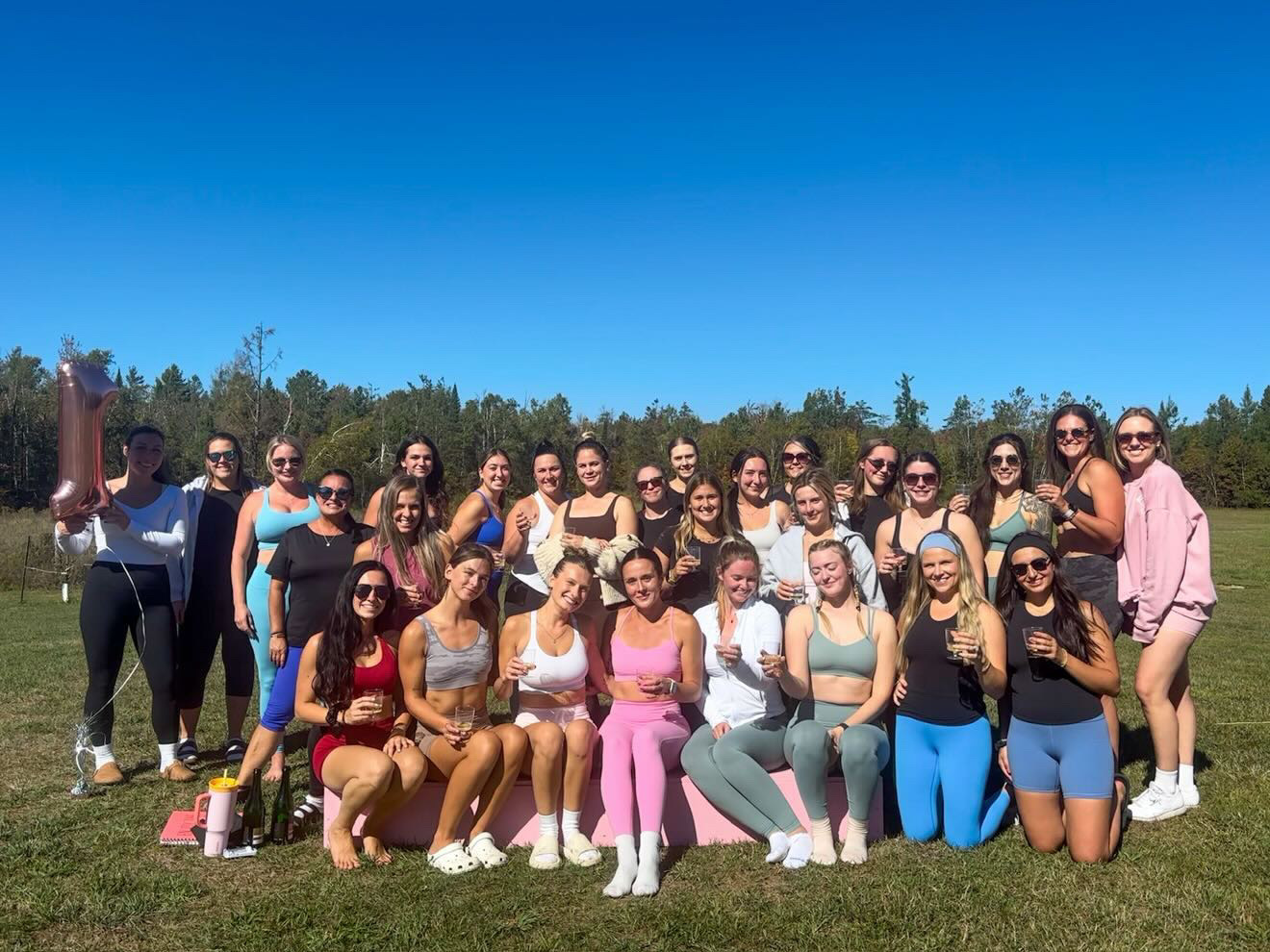 A large outdoor gathering celebrating one year of Maddie's community, before Maddog Pilates Club had a studio of its own